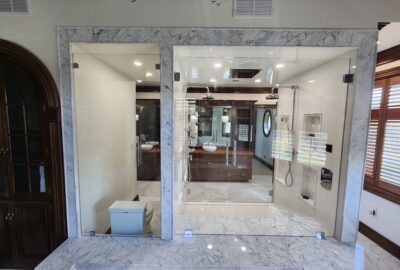 Stunning French Doors, with elegant, substantial, back-to-back ladder pulls with Rosettes, giving full access to the double shower, and a Fixed Glass Panel view for an open concept appearance. *Back View